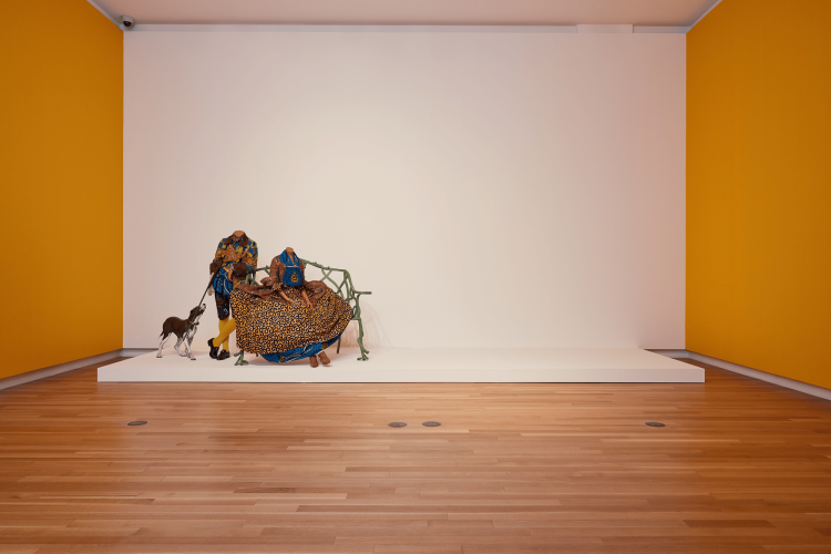 Yinka Shonibare CBE, RA Mr. and Mrs. Andrews without their Heads, 1998, two life-size mannequins, bench, gun, dog, Dutch wax printed cotton, 165 x 635 x 254 cm.  National Gallery of Canada, Ottawa. © Yinka Shonibare CBE. All Rights Reserved DACS/Artimage 2022. Photo: Rémi Thériault