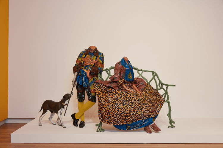 Yinka Shonibare CBE, RA Mr. and Mrs. Andrews without their Heads, 1998, two life-size mannequins, bench, gun, dog, Dutch wax printed cotton, 165 x 635 x 254 cm.  National Gallery of Canada, Ottawa. © Yinka Shonibare CBE. All Rights Reserved DACS/Artimage 2022. Photo: Rémi Thériault