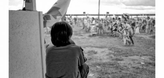 Jeff Thomas, Young Boy Watching the Powwow, Long Plains Powwow, Manitoba, c. 1989, silver gelatin print. Courtesy of the artist