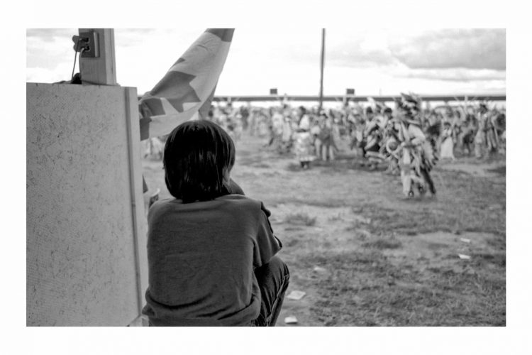 Jeff Thomas, Young Boy Watching the Powwow, Long Plains Powwow, Manitoba, c. 1989, silver gelatin print. Courtesy of the artist